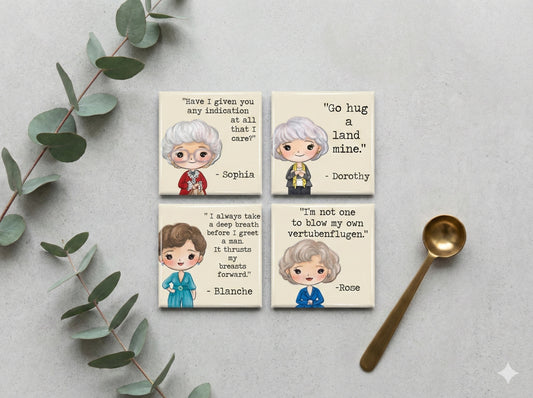 Four square magnets with the Golden Girls and quotes on a light gray background with eucalyptus leaves and a spoon.
